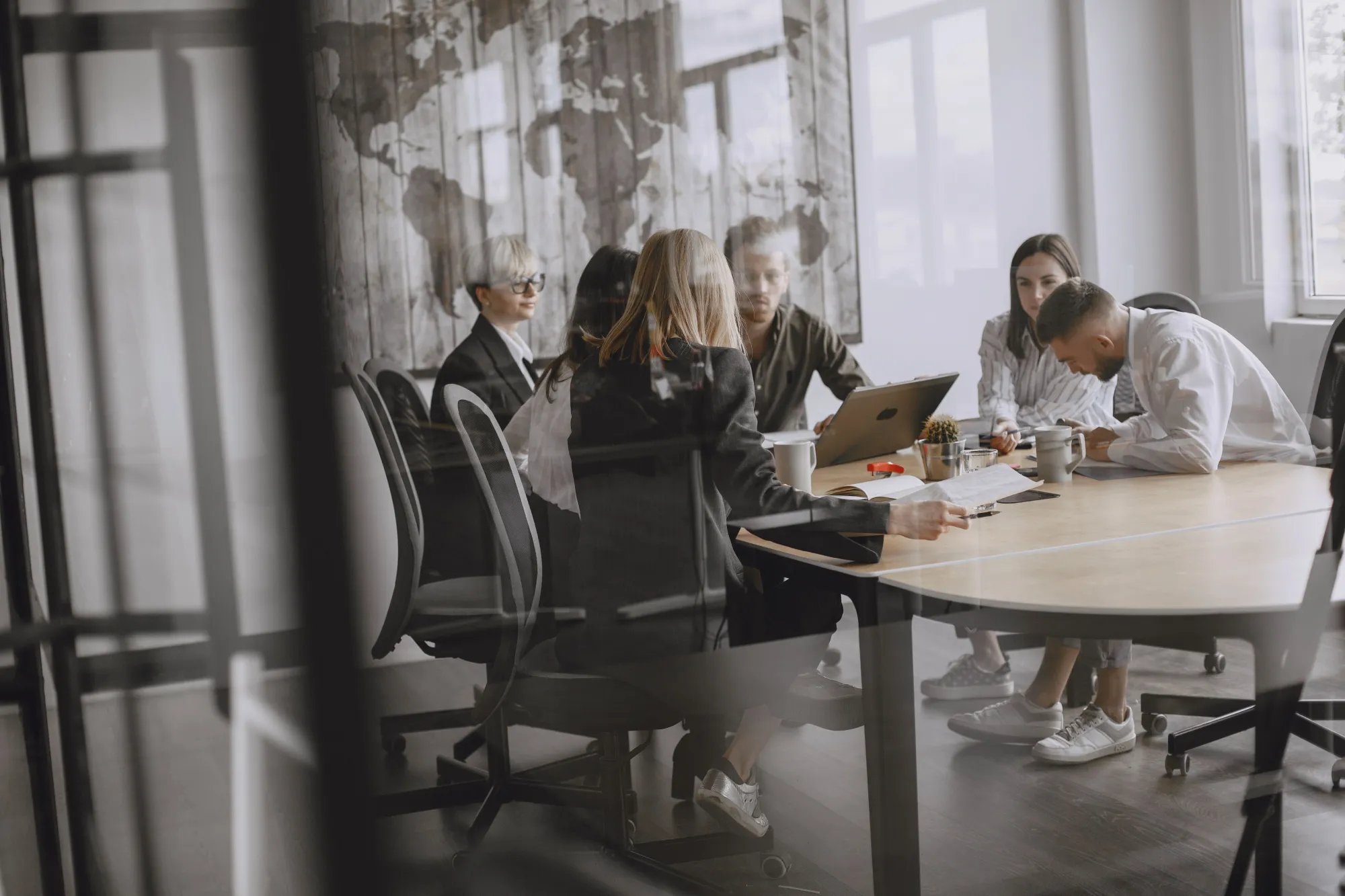 Commercial insurance advisor meeting with a client at a conference table