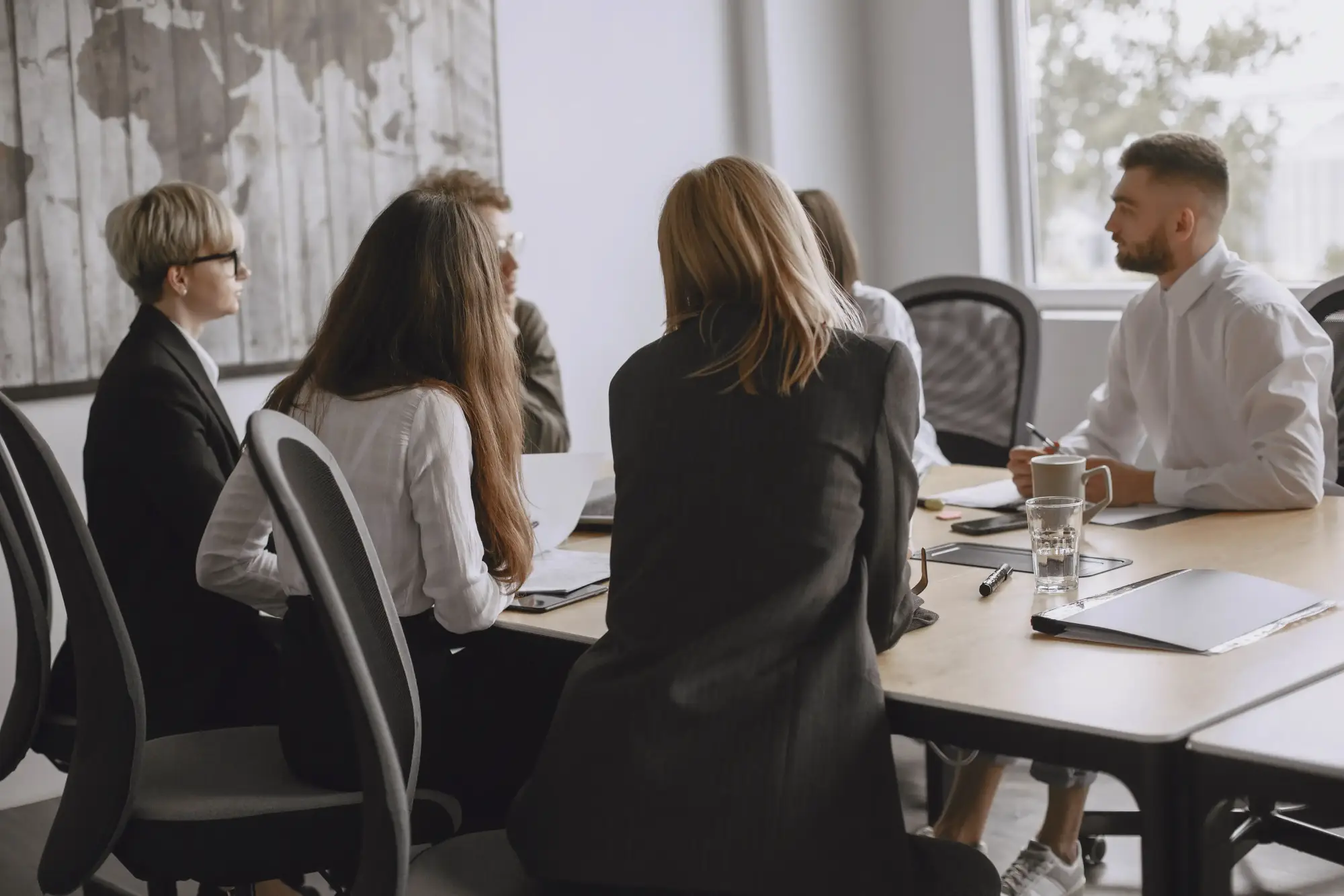 Commercial insurance advisor meeting with clients in a professional office